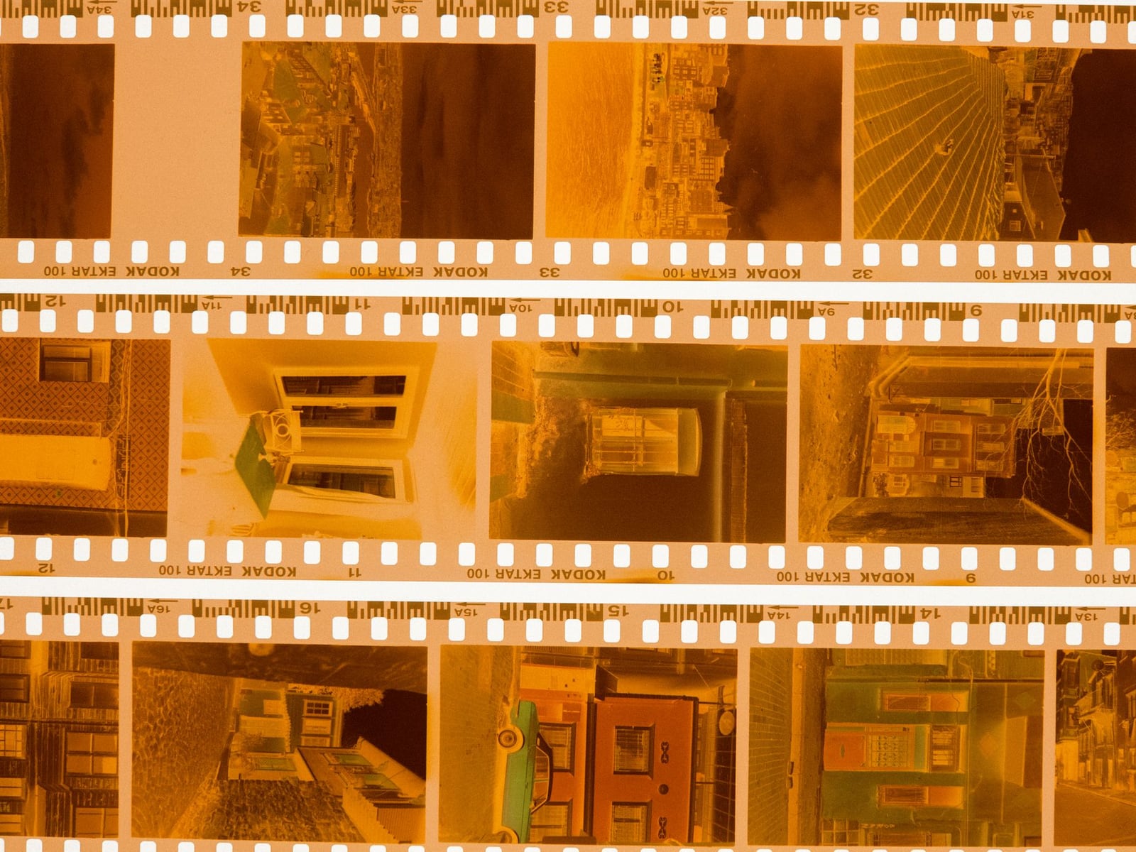 A 35mm film negative being handled with professional archival gloves.